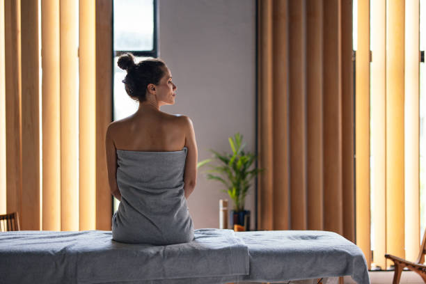 Figure-four hip stretch on a bed